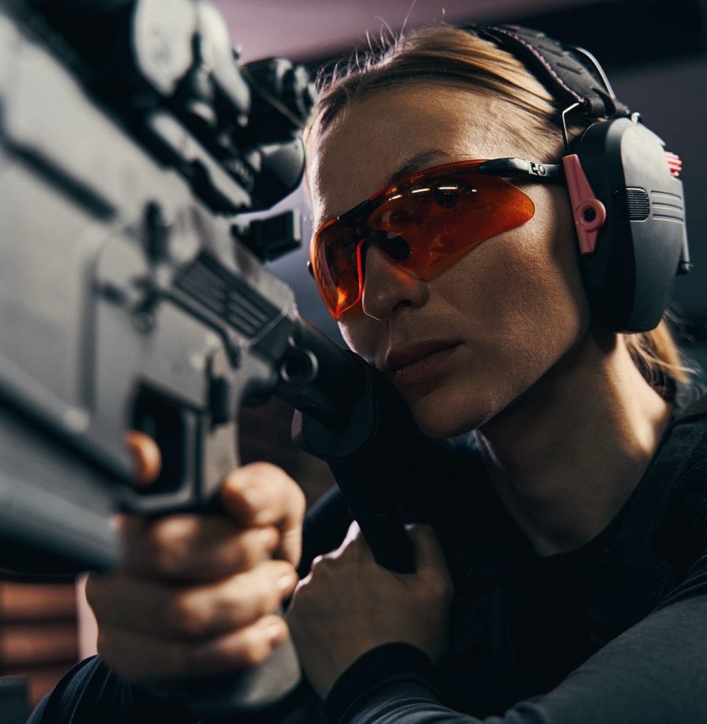 female-shooter-in-safety-goggles-firing-a-weapon.jpg